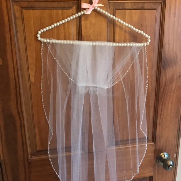 Sleek medium length white veil with beaded trim